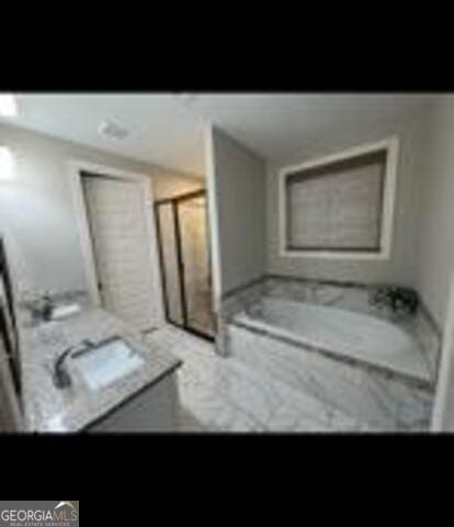 406 Clifton Rd, Perry, GA 31069 - full bathroom with vanity, a bath, and marble finish flooring