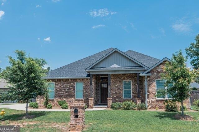 406 Clifton Rd, Perry, GA 31069 - craftsman-style home featuring a front lawn, brick siding, and roof with shingles