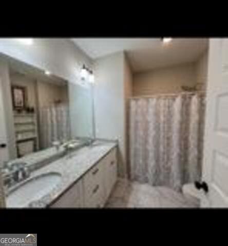 406 Clifton Rd, Perry, GA 31069 - bathroom featuring double vanity and a shower with curtain