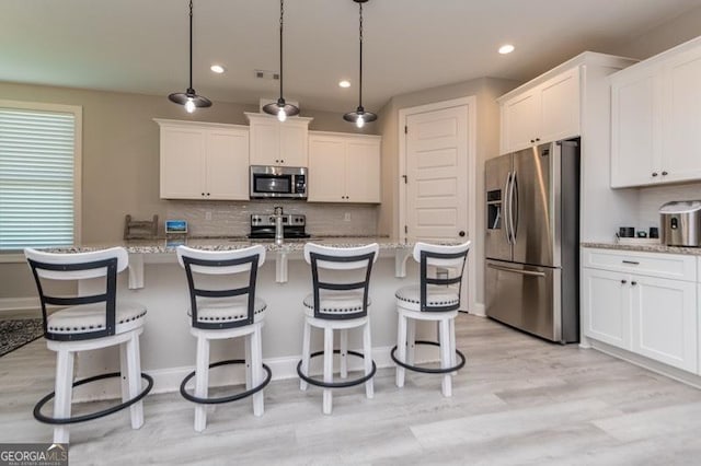 406 Clifton Rd, Perry, GA 31069 - kitchen with stainless steel appliances, white cabinetry, decorative backsplash, and recessed lighting