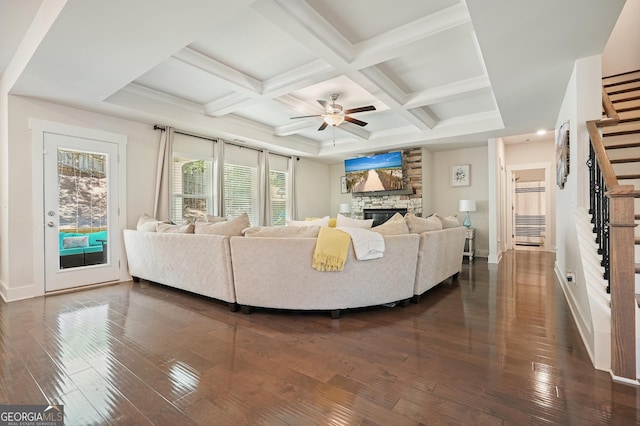 383 Crestbrook Ln, Dallas, GA 30157 - living room with stairway, ceiling fan, dark wood-style floors, a stone fireplace, and beamed ceiling
