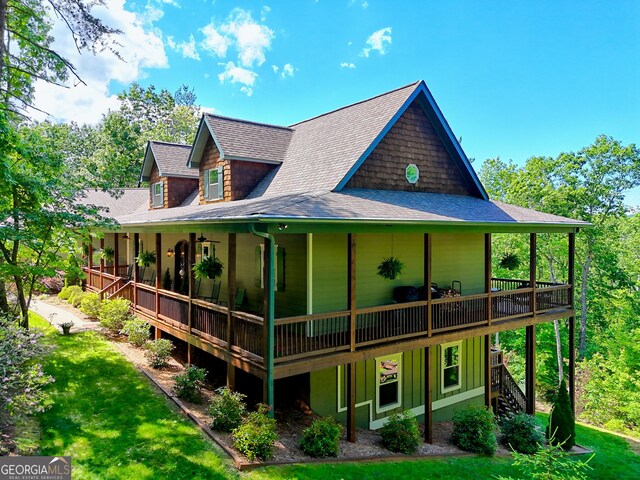 421 Hickory Nut Mountain Rd, Tallulah Falls, GA 30573 - rear view of house featuring roof with shingles, a wooden deck, stairway, and a yard