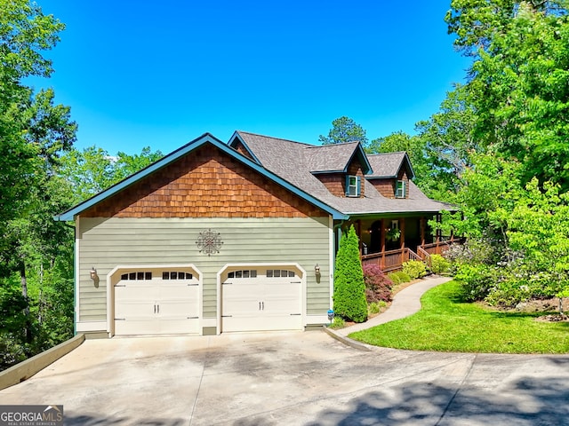 421 Hickory Nut Mountain Rd, Tallulah Falls, GA 30573 - view of front facade with concrete driveway, covered porch, an attached garage, and roof with shingles