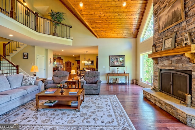 421 Hickory Nut Mountain Rd, Tallulah Falls, GA 30573 - living room featuring high vaulted ceiling, stairs, dark wood-type flooring, a fireplace, and wooden ceiling