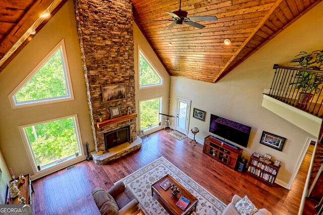 421 Hickory Nut Mountain Rd, Tallulah Falls, GA 30573 - living room with high vaulted ceiling, wood ceiling, a stone fireplace, a ceiling fan, and hardwood / wood-style floors
