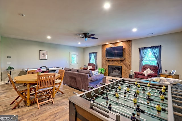 421 Hickory Nut Mountain Rd, Tallulah Falls, GA 30573 - rec room featuring recessed lighting, plenty of natural light, a large fireplace, a ceiling fan, and light wood-style floors