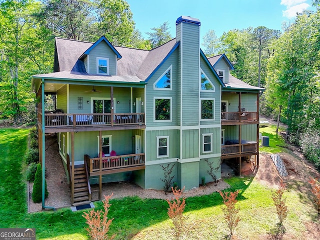 421 Hickory Nut Mountain Rd, Tallulah Falls, GA 30573 - rear view of property featuring a chimney, a ceiling fan, a deck, and a lawn