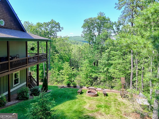 421 Hickory Nut Mountain Rd, Tallulah Falls, GA 30573 - view of grassy yard with an outdoor fire pit, stairs, a wooden deck, and a view of trees