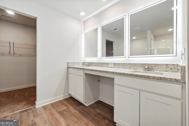 768 Great Oak Pl Unit 26, Villa Rica, GA 30180 - full bathroom with double vanity, wood finished floors, a spacious closet, and baseboards