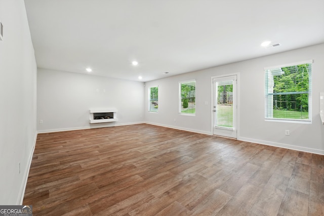 768 Great Oak Pl Unit 26, Villa Rica, GA 30180 - unfurnished living room with wood finished floors, a fireplace, baseboards, and recessed lighting