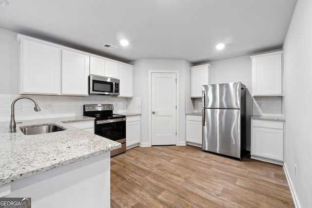 768 Great Oak Pl Unit 26, Villa Rica, GA 30180 - kitchen featuring stainless steel appliances, a sink, backsplash, white cabinets, and recessed lighting