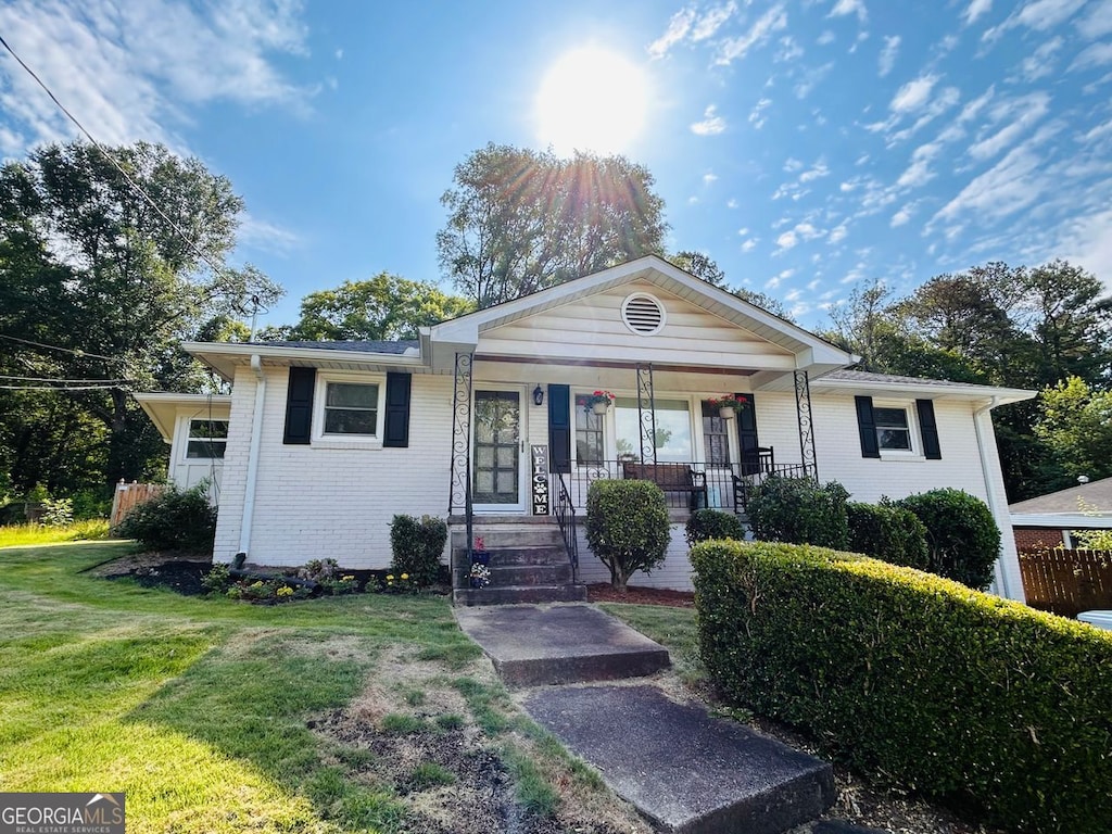 3215 Woodview, Smyrna, GA 30082 - ranch-style house with brick siding, a front yard, and covered porch