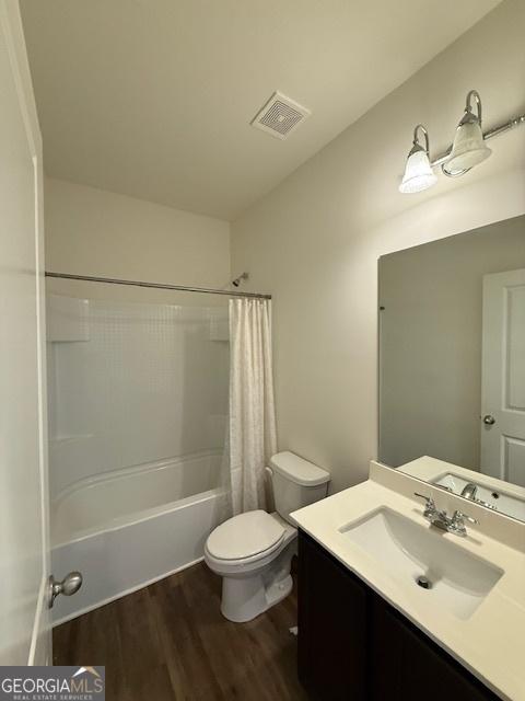 170 Forray Dr, Covington, GA 30016 - full bathroom featuring wood finished floors, vanity, toilet, and shower / bath combo