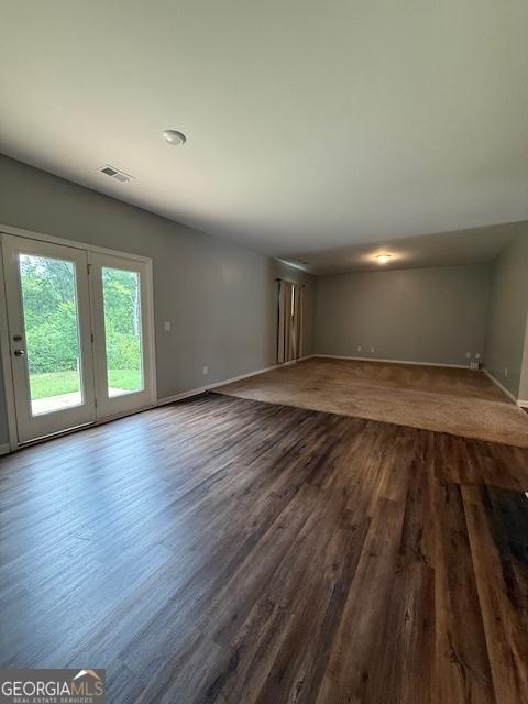 170 Forray Dr, Covington, GA 30016 - unfurnished living room with baseboards and dark wood finished floors