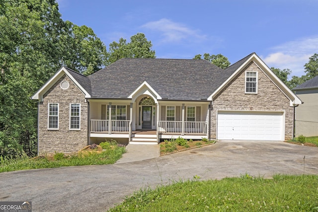 5523 River Valley Way, Flowery Branch, GA 30542 - view of front of home featuring a porch, stone siding, driveway, and a garage