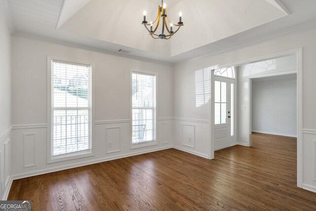 5523 River Valley Way, Flowery Branch, GA 30542 - empty room with a chandelier, a wainscoted wall, dark wood-style flooring, crown molding, and a decorative wall