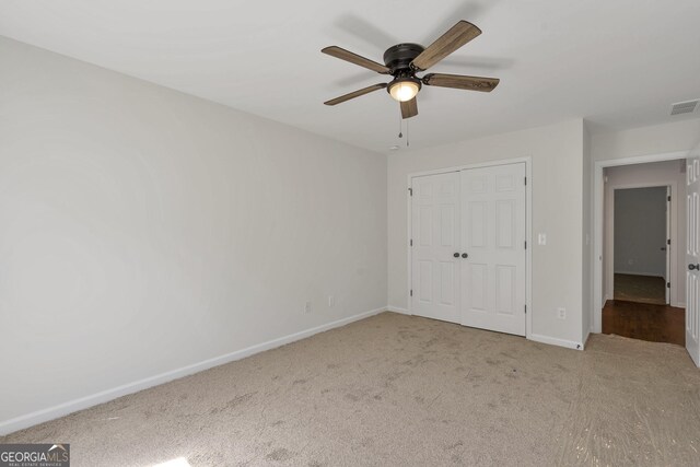 5523 River Valley Way, Flowery Branch, GA 30542 - unfurnished bedroom featuring carpet, baseboards, a closet, and a ceiling fan