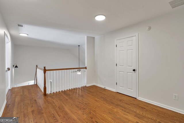 5523 River Valley Way, Flowery Branch, GA 30542 - unfurnished room featuring wood finished floors, baseboards, and a smoke detector