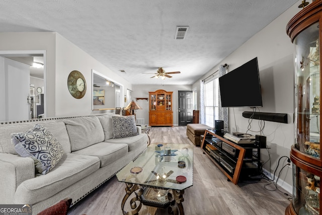 1322 Melford Dr, Columbus, GA 31907 - living room with light wood-style flooring, ceiling fan, a textured ceiling, and baseboards
