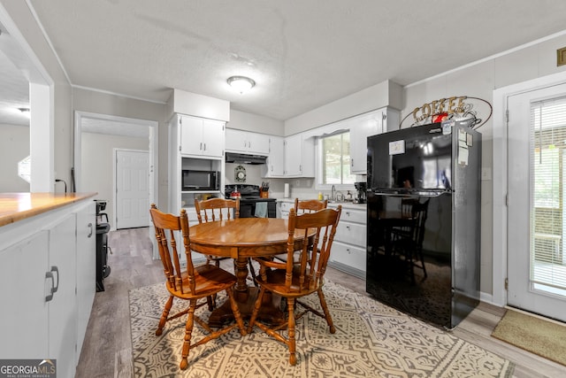 1322 Melford Dr, Columbus, GA 31907 - dining room with light wood-type flooring and a textured ceiling