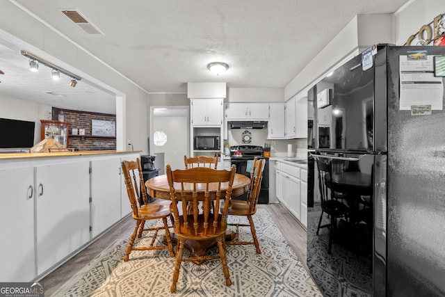 1322 Melford Dr, Columbus, GA 31907 - dining room featuring light wood finished floors and a textured ceiling