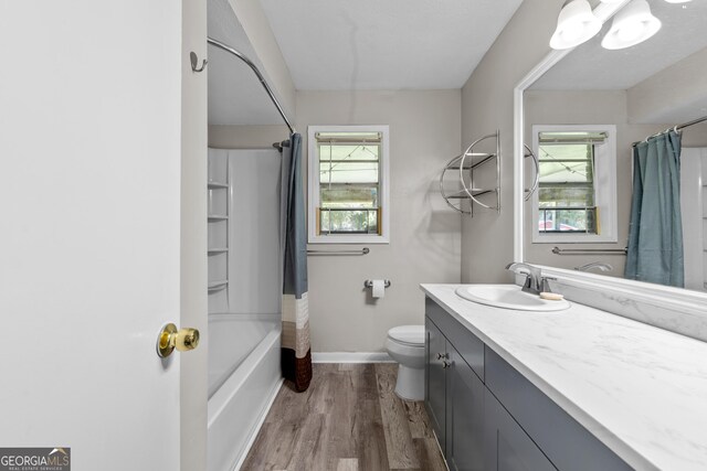 1322 Melford Dr, Columbus, GA 31907 - bathroom featuring vanity, wood finished floors, toilet, baseboards, and shower / tub combo with curtain