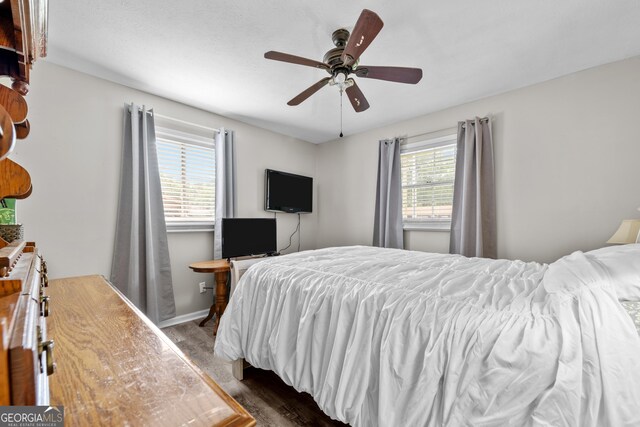 1322 Melford Dr, Columbus, GA 31907 - bedroom with dark wood-style floors, ceiling fan, and baseboards