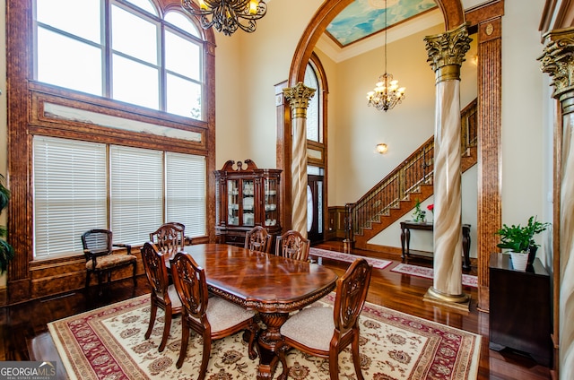 2120 Shaffer Rd, Cumming, GA 30041 - dining area with a chandelier, crown molding, wood finished floors, a high ceiling, and decorative columns
