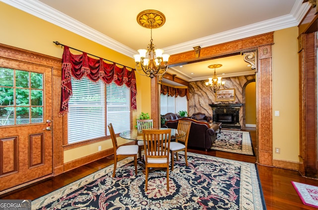 2120 Shaffer Rd, Cumming, GA 30041 - dining room with a chandelier, wood-type flooring, crown molding, a fireplace, and baseboards