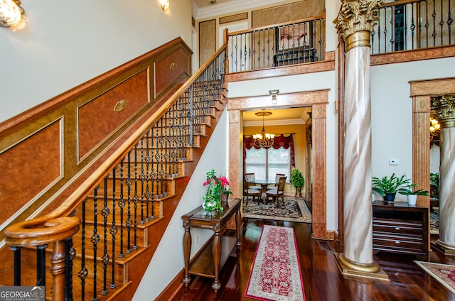 2120 Shaffer Rd, Cumming, GA 30041 - stairway with a chandelier, a towering ceiling, crown molding, wood finished floors, and baseboards