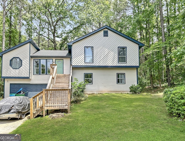 2816 Quinbery Dr, Snellville, GA 30039 - rear view of house featuring stairs, a garage, a lawn, and view of wooded area