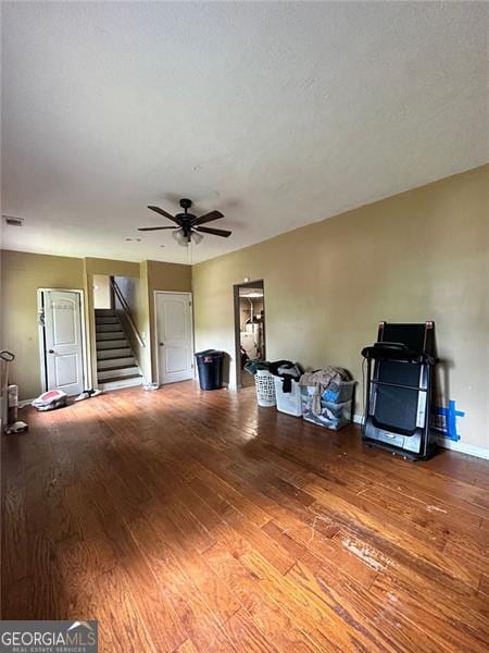 2816 Quinbery Dr, Snellville, GA 30039 - unfurnished living room featuring stairway, a ceiling fan, wood finished floors, and baseboards