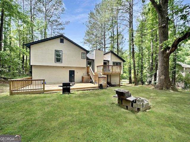 2816 Quinbery Dr, Snellville, GA 30039 - rear view of property featuring a wooden deck, stairs, a yard, and an outdoor fire pit