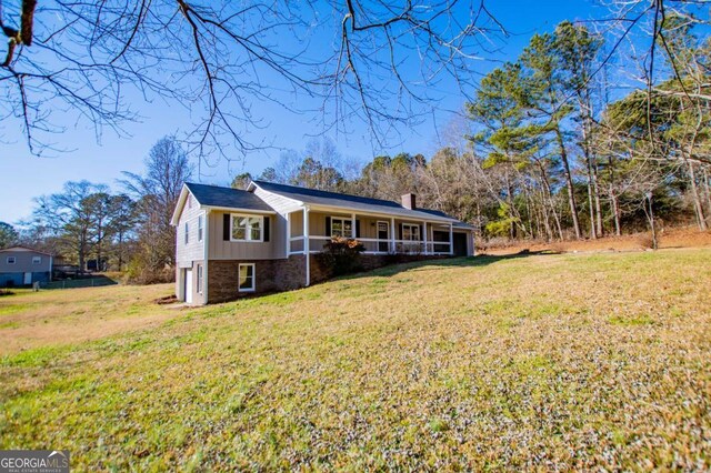 280 Hitchcock Rd, Dallas, GA 30157 - single story home with a chimney, a front lawn, board and batten siding, and brick siding