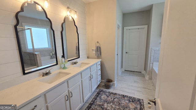 2321 Margaux Ct, Monroe, GA 30656 - bathroom with marble look tile flooring, a garden tub, double vanity, an enclosed shower, and baseboards