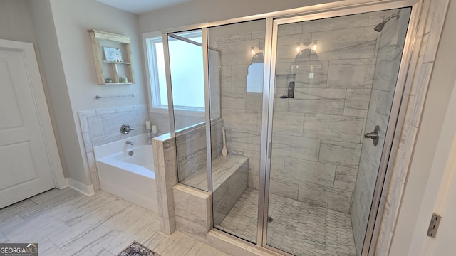 2321 Margaux Ct, Monroe, GA 30656 - bathroom featuring a garden tub, a shower stall, and baseboards