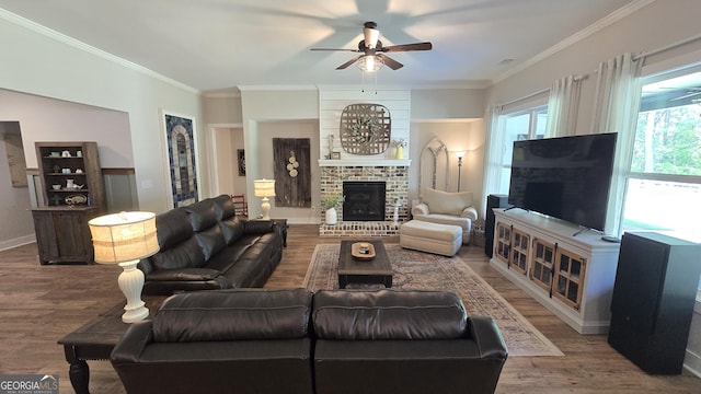 2321 Margaux Ct, Monroe, GA 30656 - living room with ceiling fan, a brick fireplace, wood finished floors, ornamental molding, and baseboards