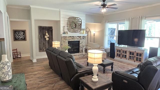 2321 Margaux Ct, Monroe, GA 30656 - living room featuring ceiling fan, wood finished floors, ornamental molding, a brick fireplace, and baseboards
