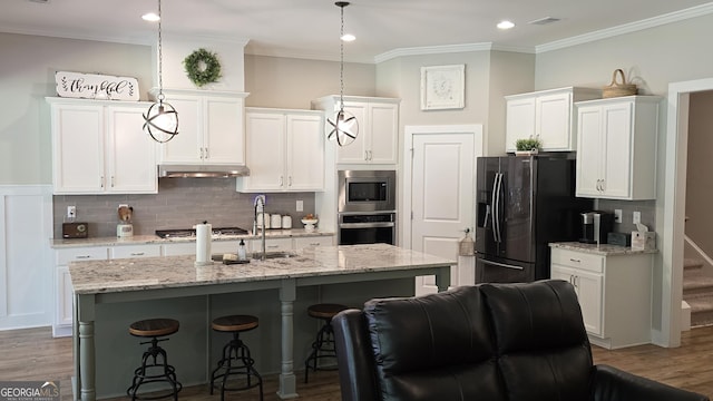 2321 Margaux Ct, Monroe, GA 30656 - kitchen featuring stainless steel appliances, white cabinetry, ornamental molding, a breakfast bar area, and recessed lighting