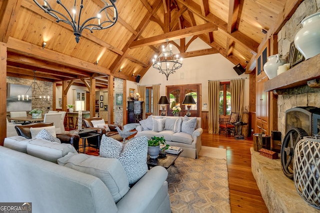 4334 Murray Cove Rd, Tiger, GA 30576 - living area with a chandelier, hardwood / wood-style flooring, wooden ceiling with exposed beams, high vaulted ceiling, and a wainscoted wall