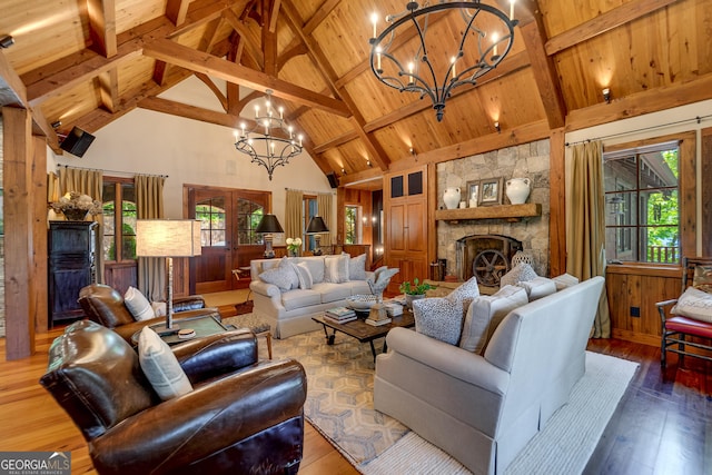 4334 Murray Cove Rd, Tiger, GA 30576 - living room with a chandelier, high vaulted ceiling, wood-type flooring, wooden ceiling with exposed beams, and a stone fireplace