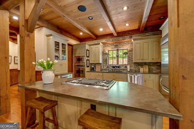 4334 Murray Cove Rd, Tiger, GA 30576 - kitchen featuring stainless steel appliances, cream cabinetry, wooden ceiling with exposed beams, a breakfast bar area, and light wood-type flooring