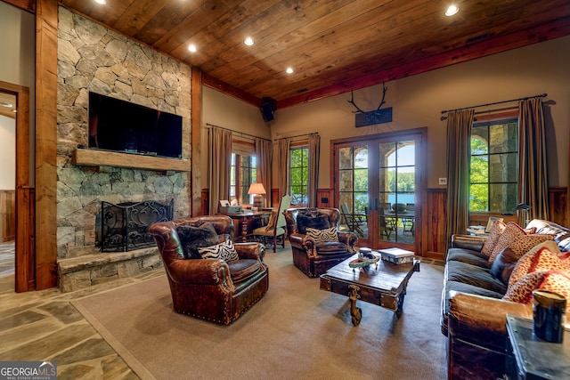 4334 Murray Cove Rd, Tiger, GA 30576 - living area with wooden ceiling, recessed lighting, a wainscoted wall, a stone fireplace, and plenty of natural light