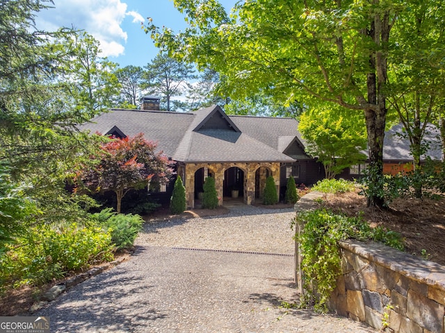 4334 Murray Cove Rd, Tiger, GA 30576 - view of front of house with covered porch, stone siding, a shingled roof, and a chimney