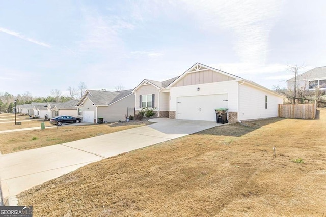 115 Taylor Woods Ct, Bonaire, GA 31005 - craftsman-style home with board and batten siding, a garage, concrete driveway, and brick siding
