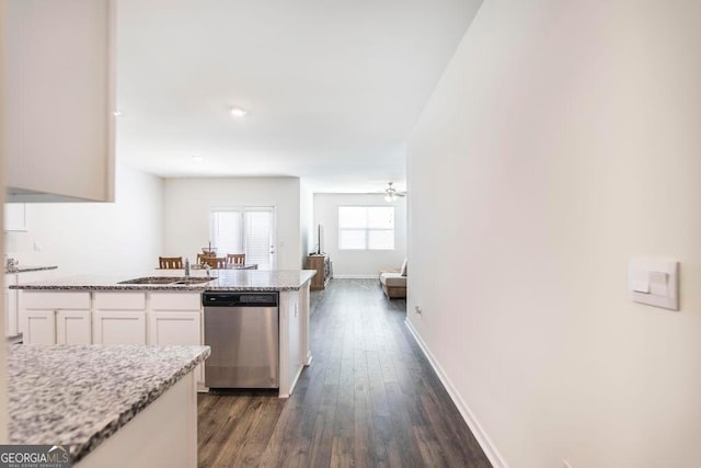 115 Taylor Woods Ct, Bonaire, GA 31005 - kitchen with stainless steel dishwasher, white cabinetry, dark wood-style flooring, baseboards, and light stone counters