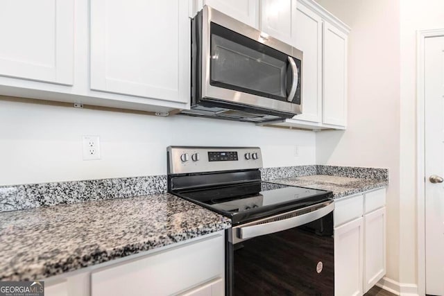 115 Taylor Woods Ct, Bonaire, GA 31005 - kitchen featuring appliances with stainless steel finishes, white cabinetry, and light stone counters