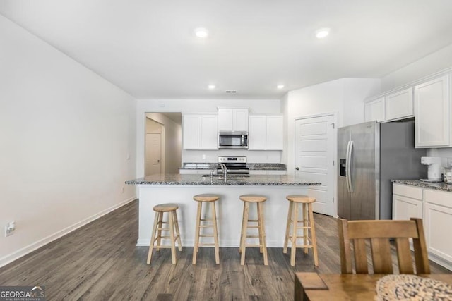 115 Taylor Woods Ct, Bonaire, GA 31005 - kitchen with stainless steel appliances, a breakfast bar, a sink, white cabinets, and dark wood-style floors