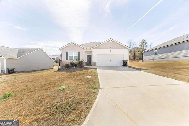115 Taylor Woods Ct, Bonaire, GA 31005 - view of front of home with board and batten siding, concrete driveway, a garage, and a front lawn