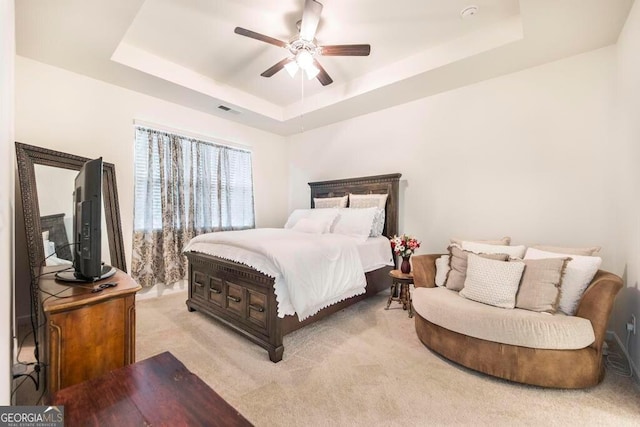 115 Taylor Woods Ct, Bonaire, GA 31005 - bedroom featuring a raised ceiling, light colored carpet, and a ceiling fan